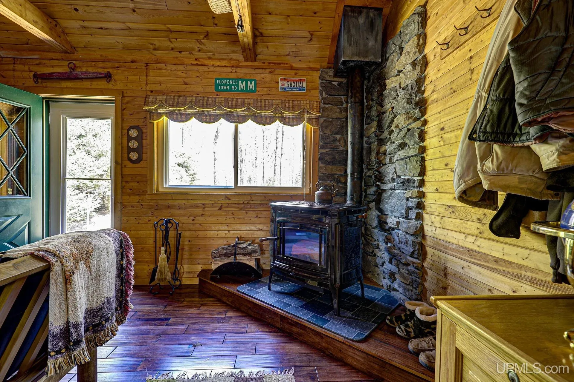 The wood stove on its stone hearth by the window