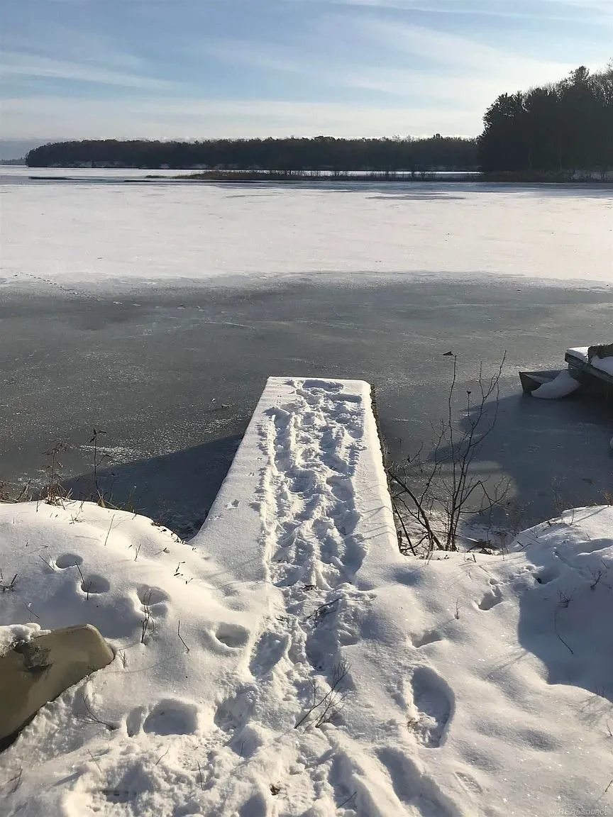 The dock under snow with the frozen lake beyond