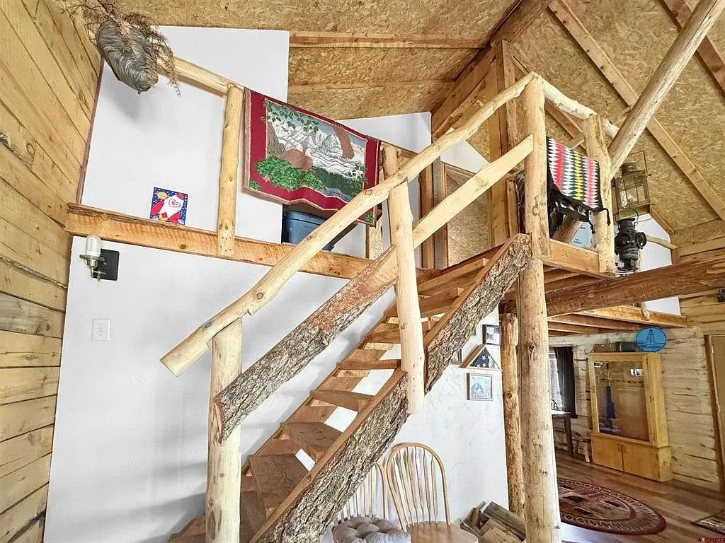 The log stair to the loft with the rail