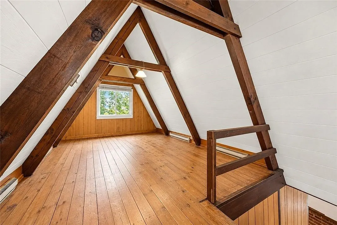 A stairway landing with wood paneling and built-in cabinets
