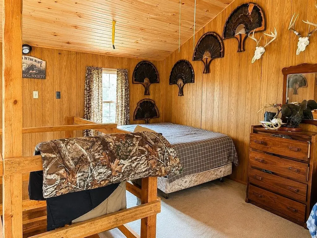 The bunk room with a dresser and mounted turkey fans