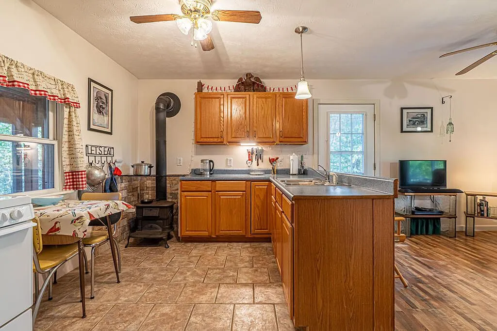 The kitchen's L-shaped counter and cabinetry with the living room beyond