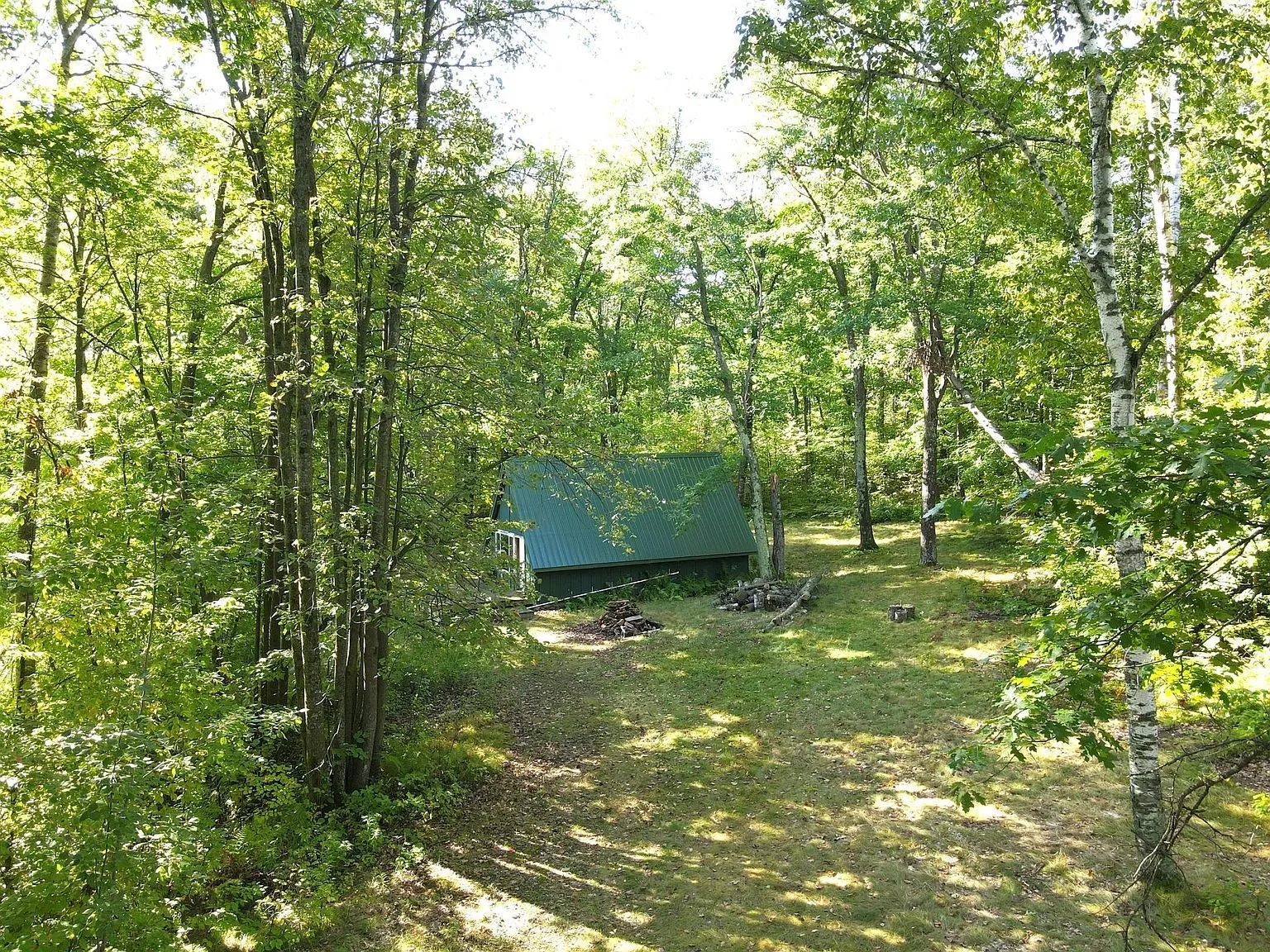 The A-frame through the trees from the yard