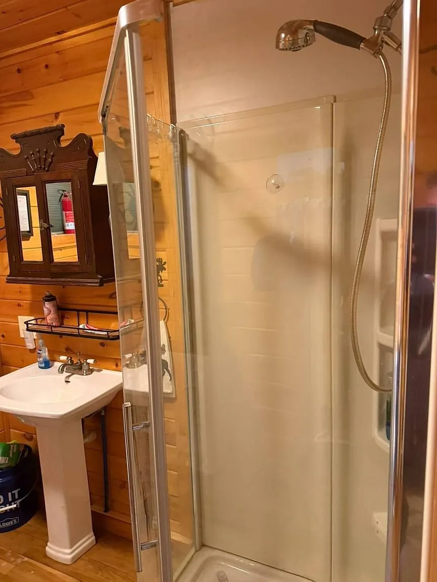 The shower stall and the pedestal sink