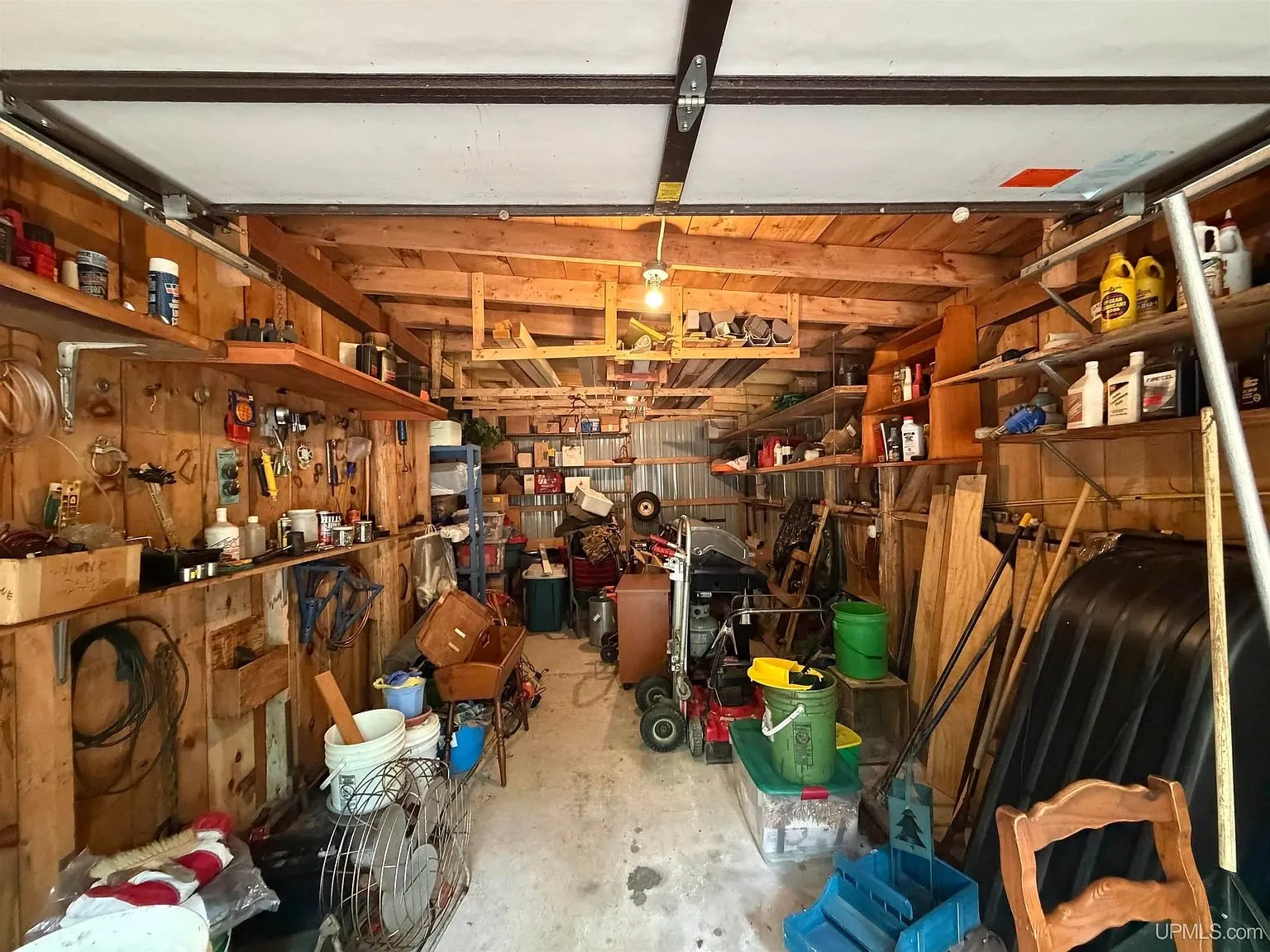 Inside the garage with tools and shelving