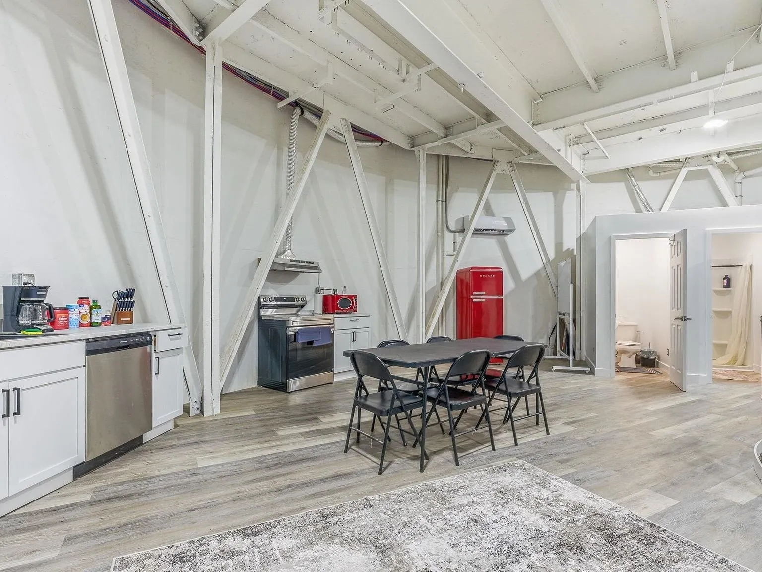 Another furnished area inside the silo with a stove, table and supply cabinet