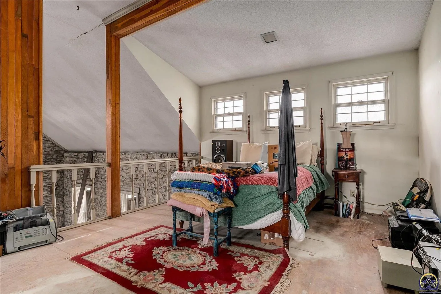 The loft bedroom over the great room with its windows and rail