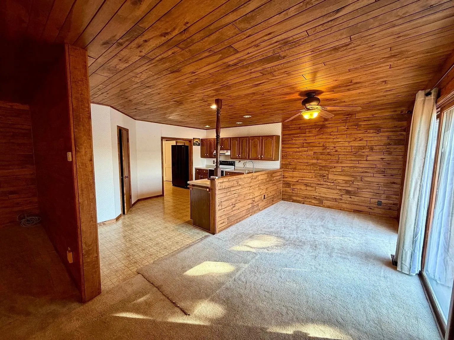 The living room toward the kitchen with the bar