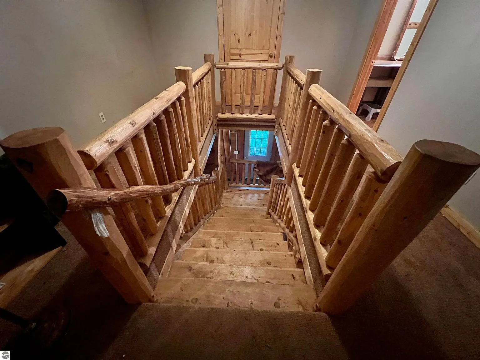 The loft rail of peeled logs over the great room
