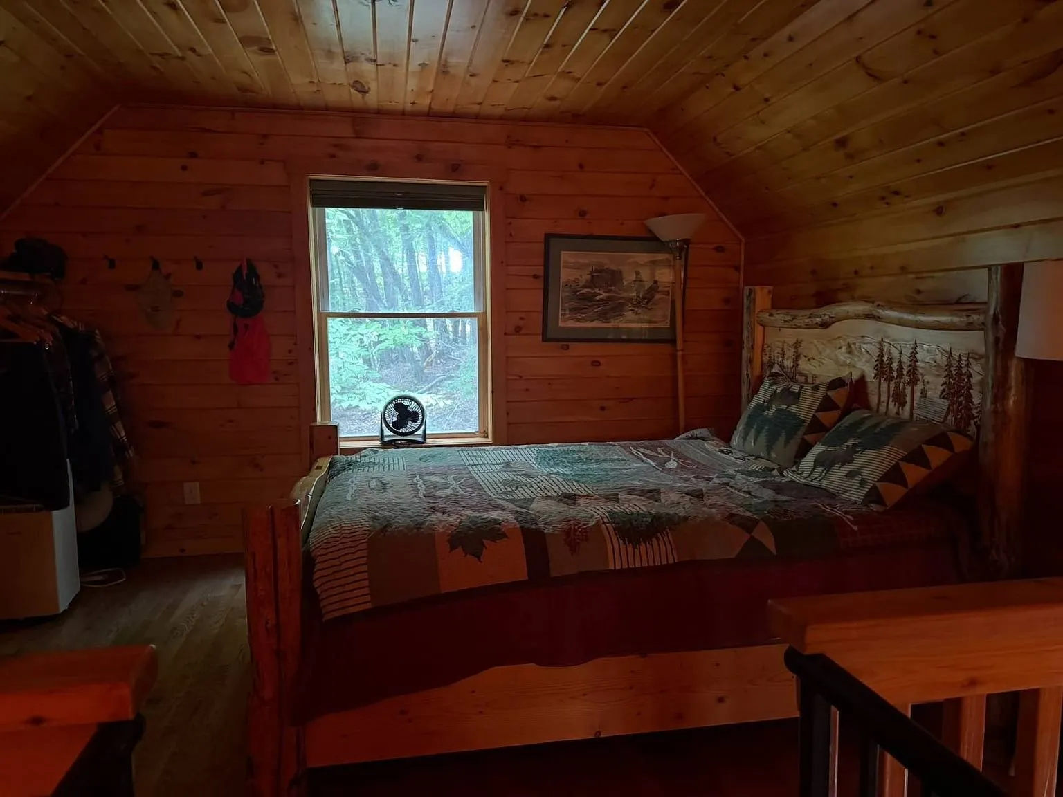 The loft bedroom with the bed under the sloped ceiling