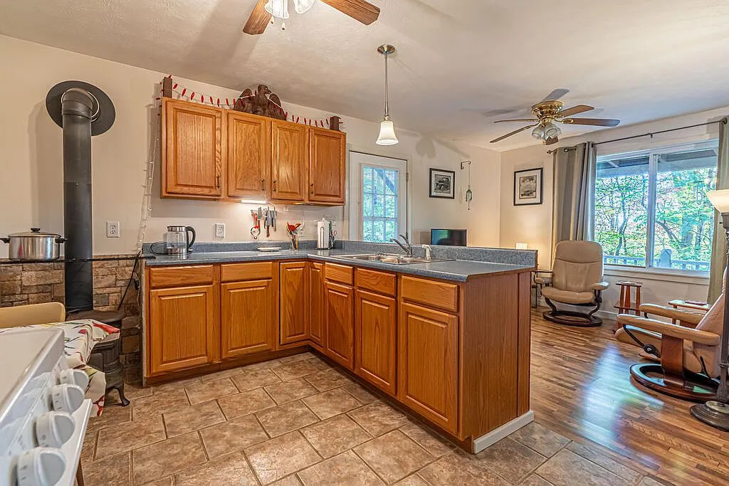 The eat-in kitchen nook with a range, wood stove and bistro table
