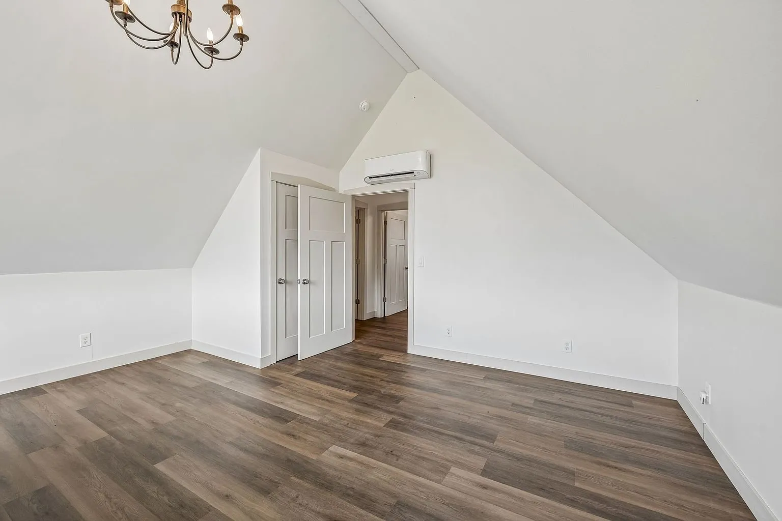 The upstairs room with the mini-split and the doors to the eaves