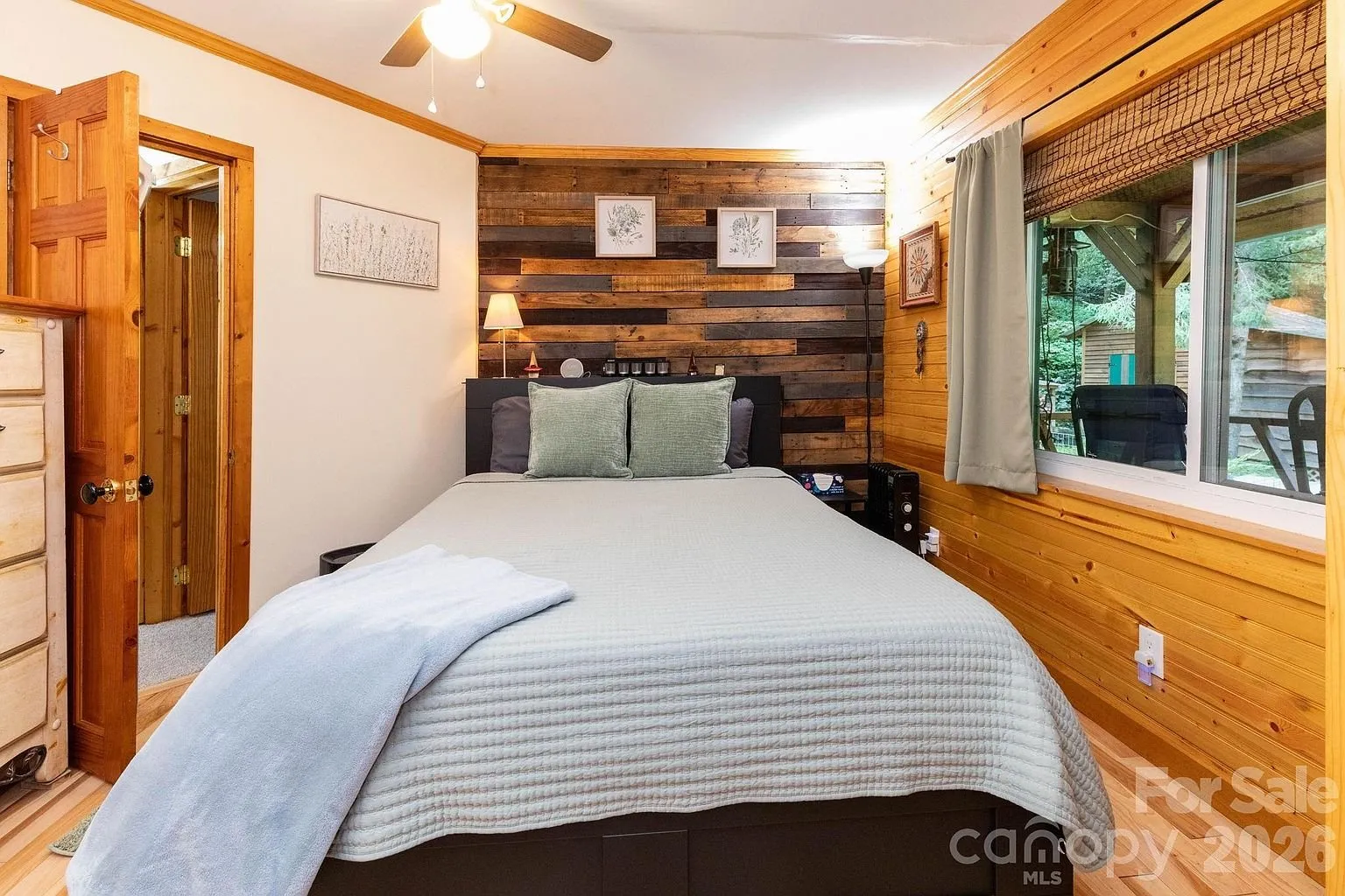 A bedroom with the reclaimed wood wall and the bed