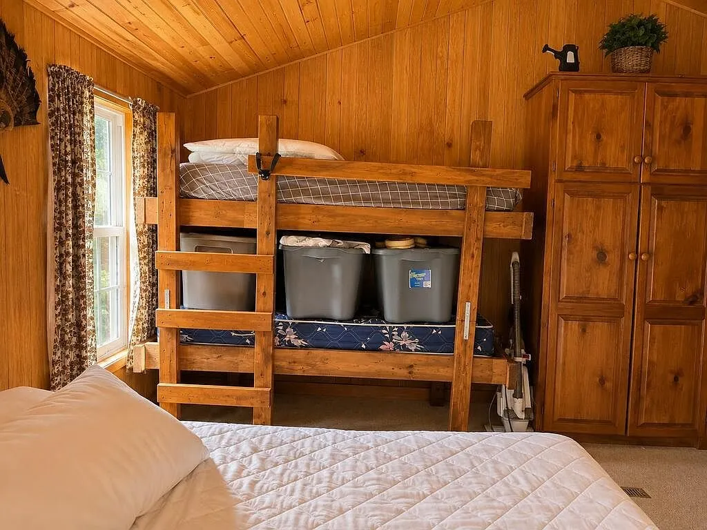 Bunk beds with storage bins beside a wardrobe