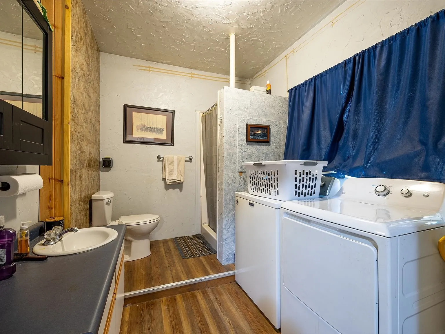 The main-level bathroom with a vanity and laundry machines