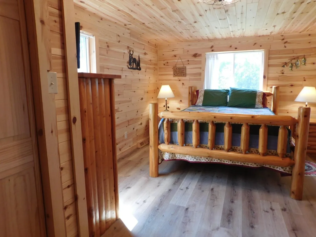The bedroom from the doorway, window above the bed