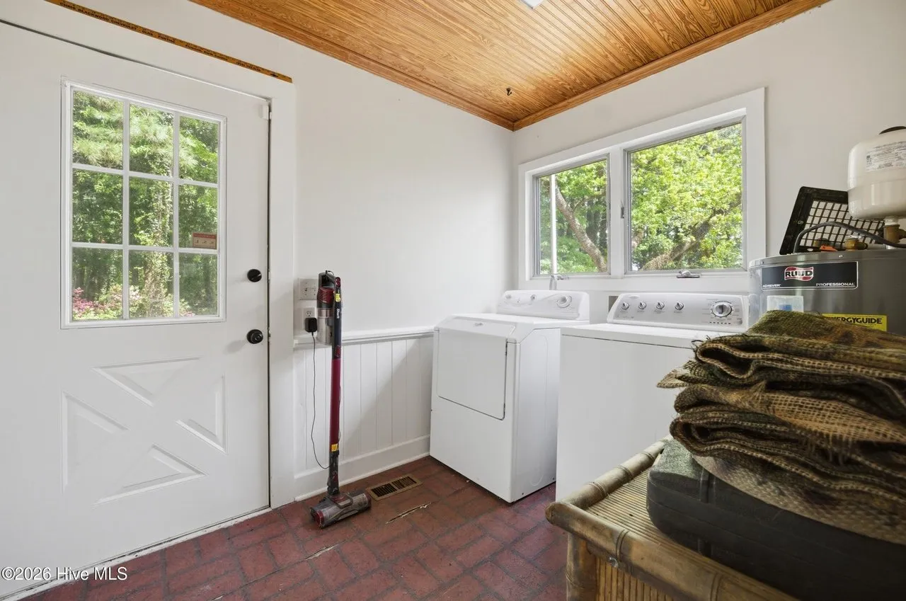 Laundry and utility room with the washer, dryer, and a door to the outside