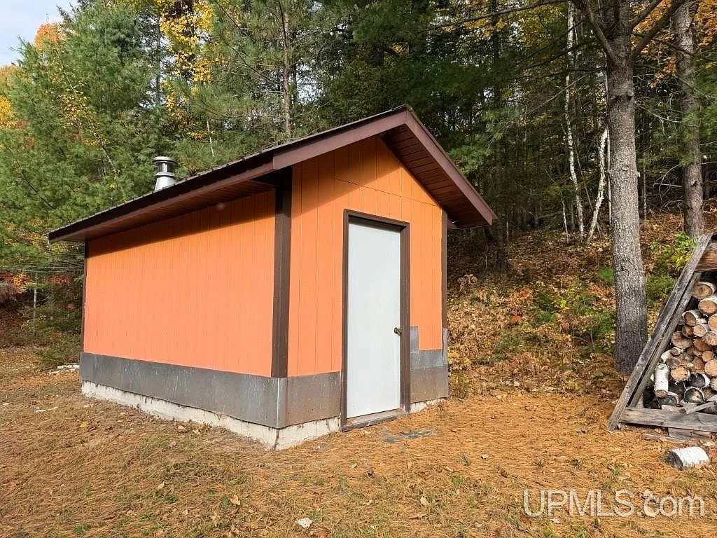 The garage interior with a vehicle parked on the concrete floor