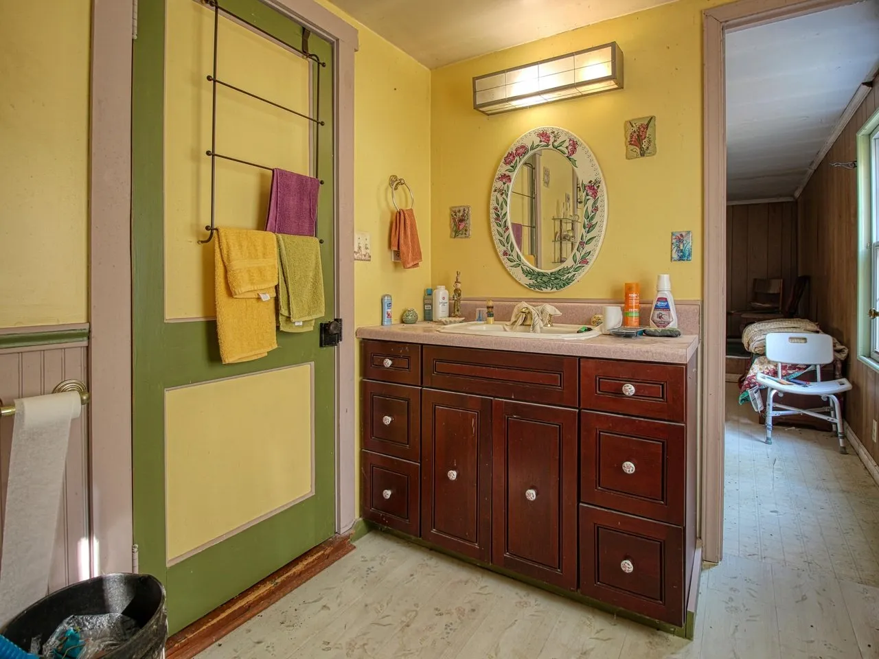 The bathroom vanity with a mirror and yellow walls