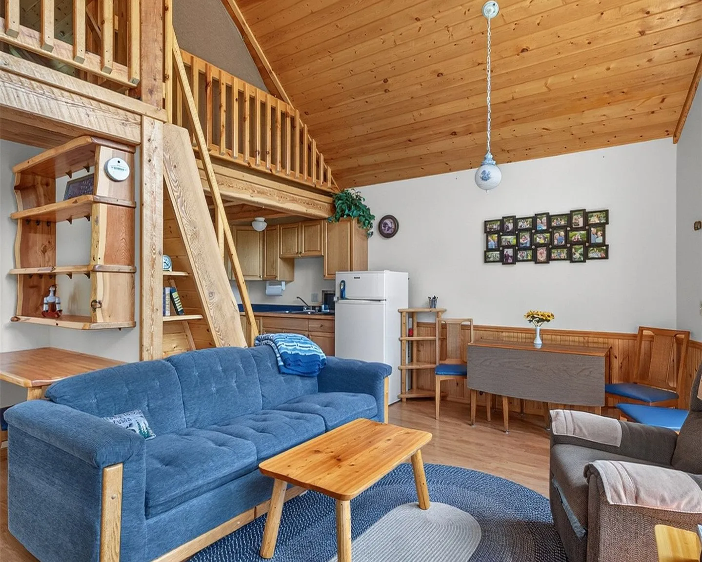 The vaulted living area's floor-to-ceiling windows and wood stove
