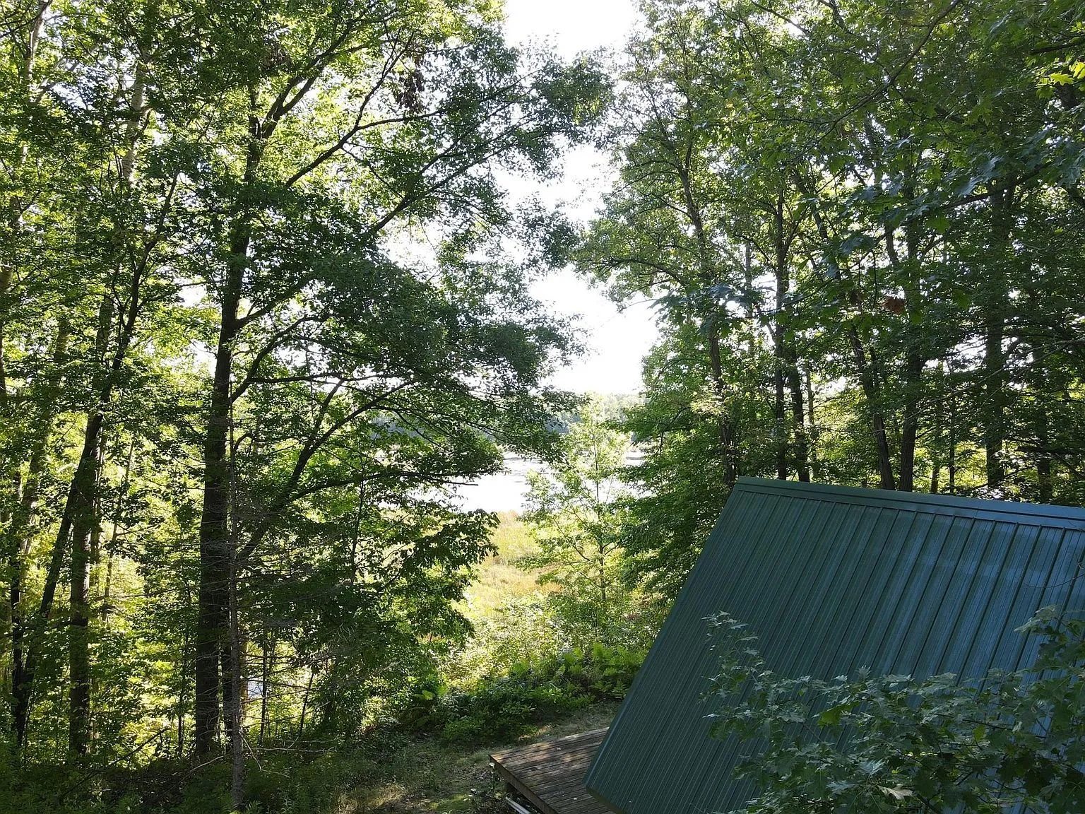 The metal roof of the A-frame from the hillside