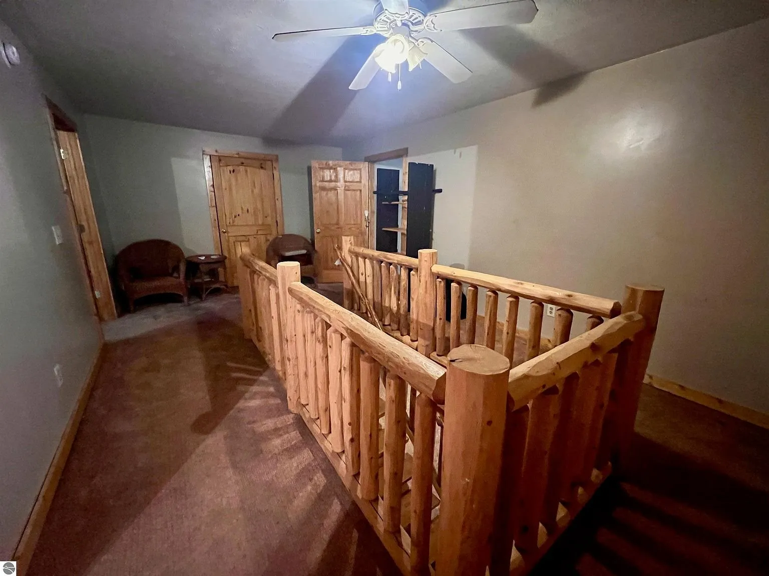 The loft landing with the log rail and the doors to the bedrooms
