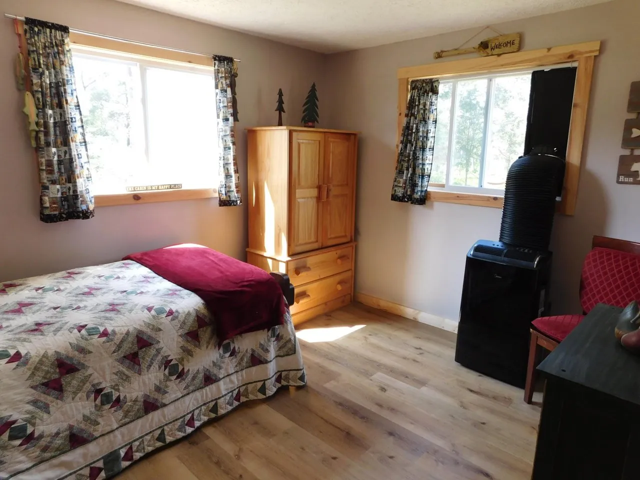 The second main floor bedroom with a wood stove in the corner