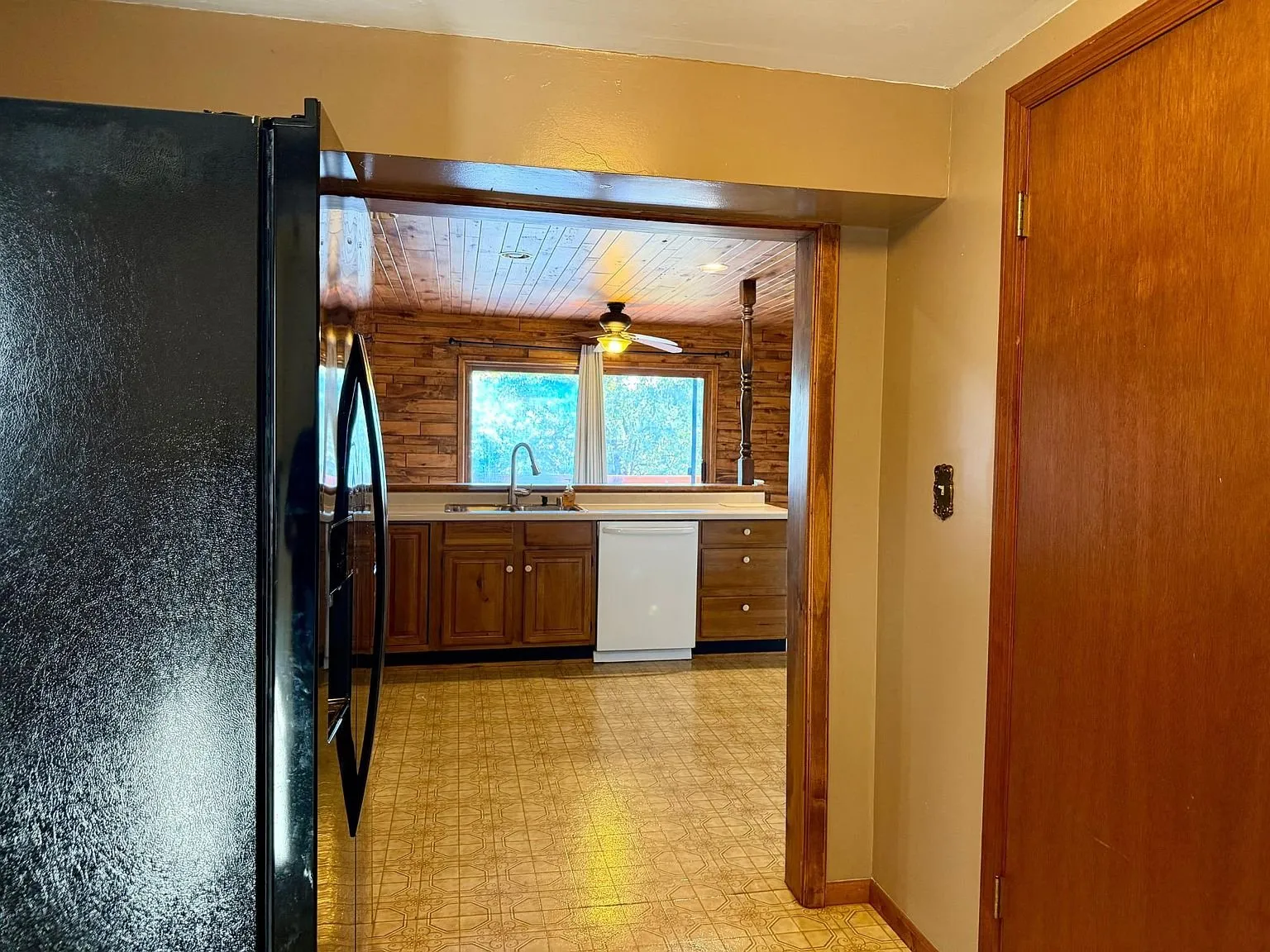 The kitchen from the foyer with the refrigerator