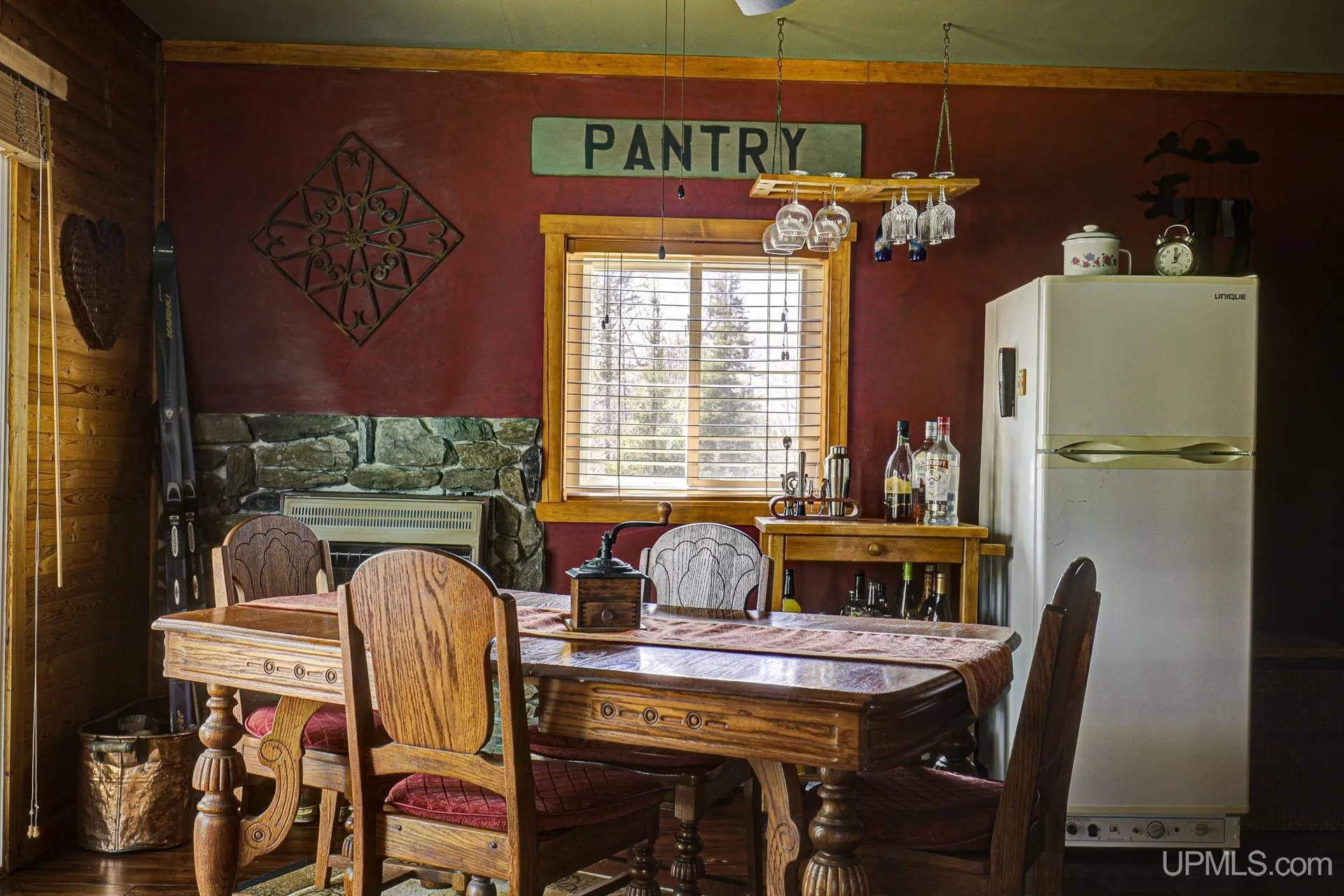 The dining table, the pantry sign and the refrigerator