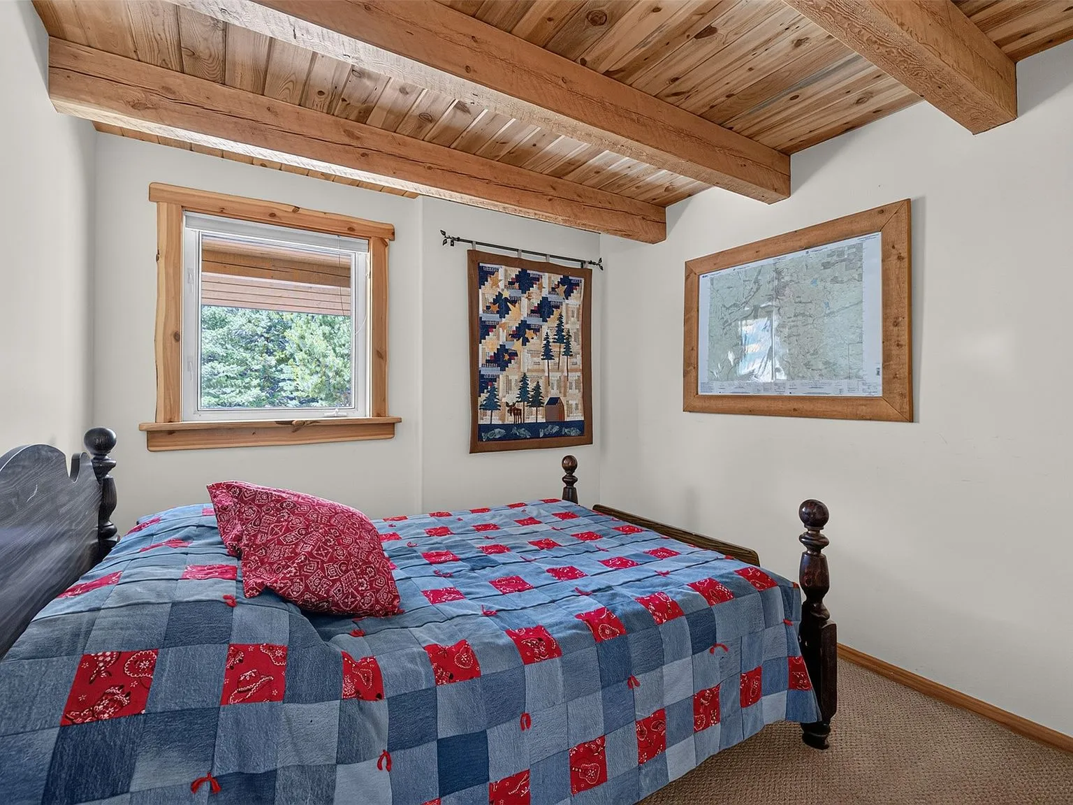 The dining and living area with a blue sofa, wood table and ceiling fan