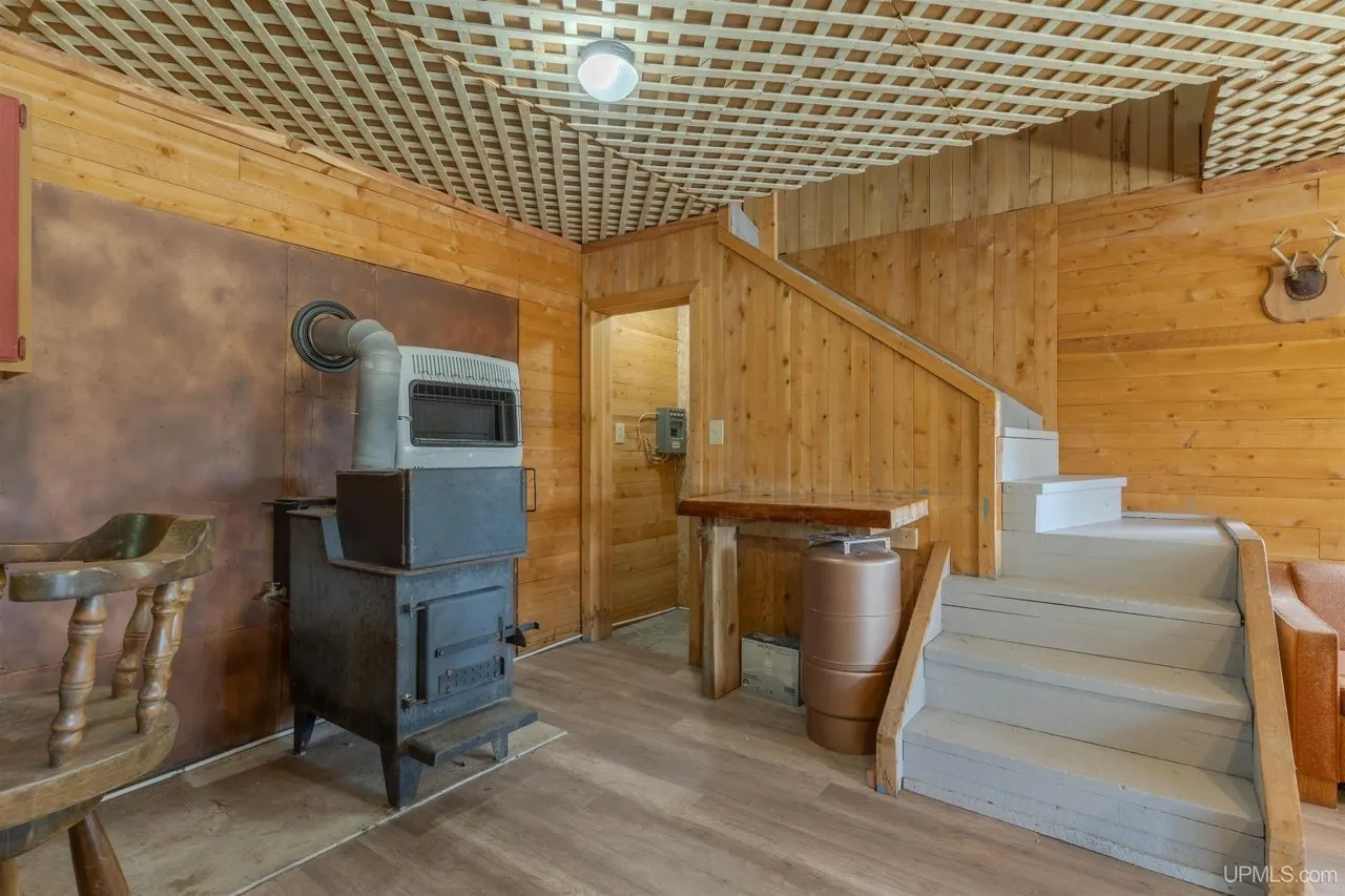 The wood stove and the stairs running up to the second floor