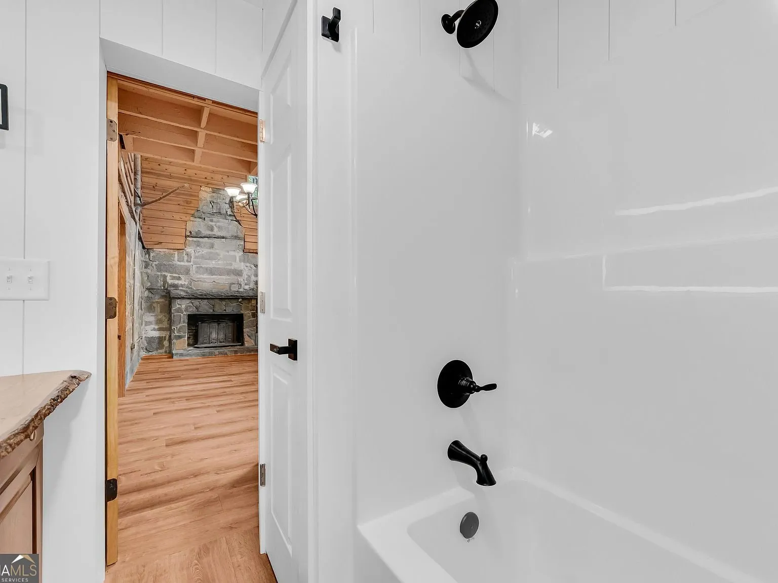 A second bathroom with a glass shower enclosure and wood cabinetry