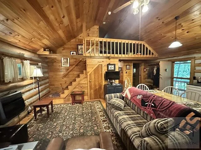 The great room with the loft rail above and the couch below