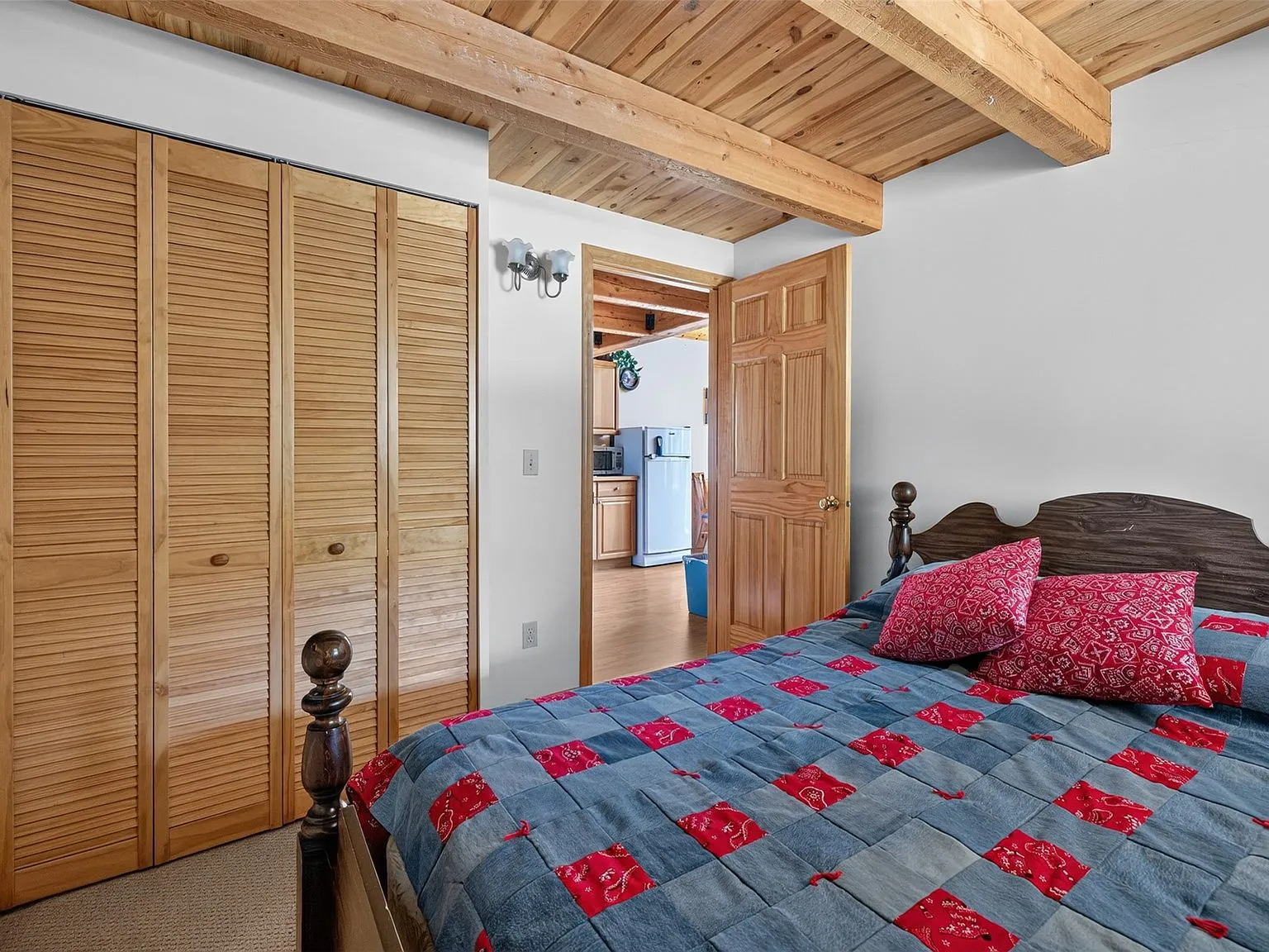 The living room's blue sofas and wood coffee table, with the loft stairs beyond