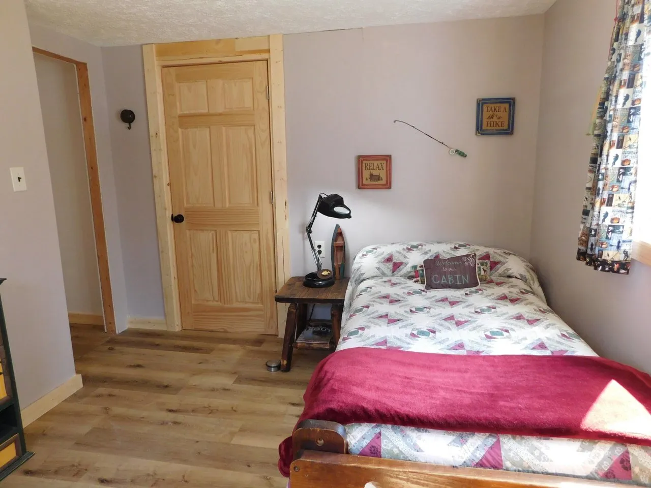 The second bedroom with a bed against the painted wall