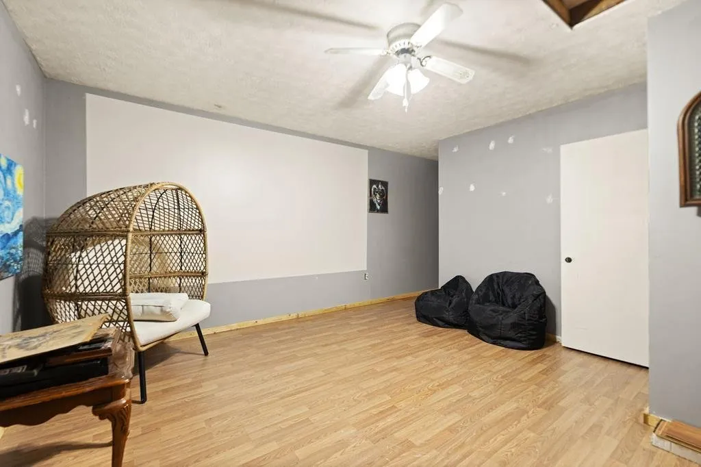 The upstairs room with two hanging chairs and a beanbag