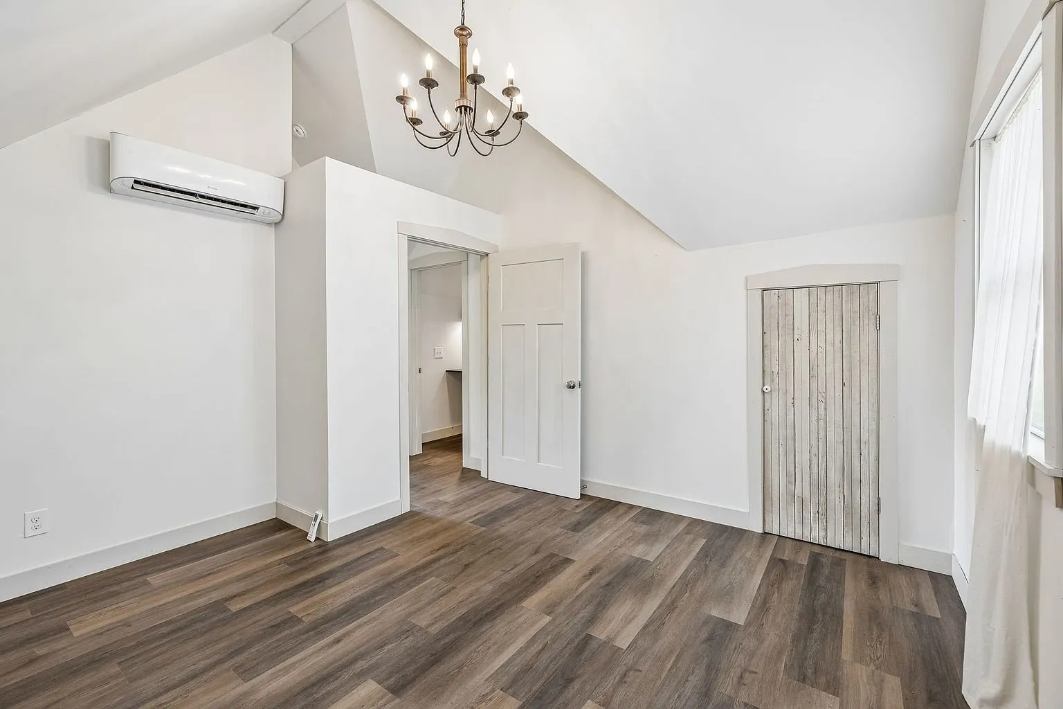 The upstairs room with the mini-split and the barn door