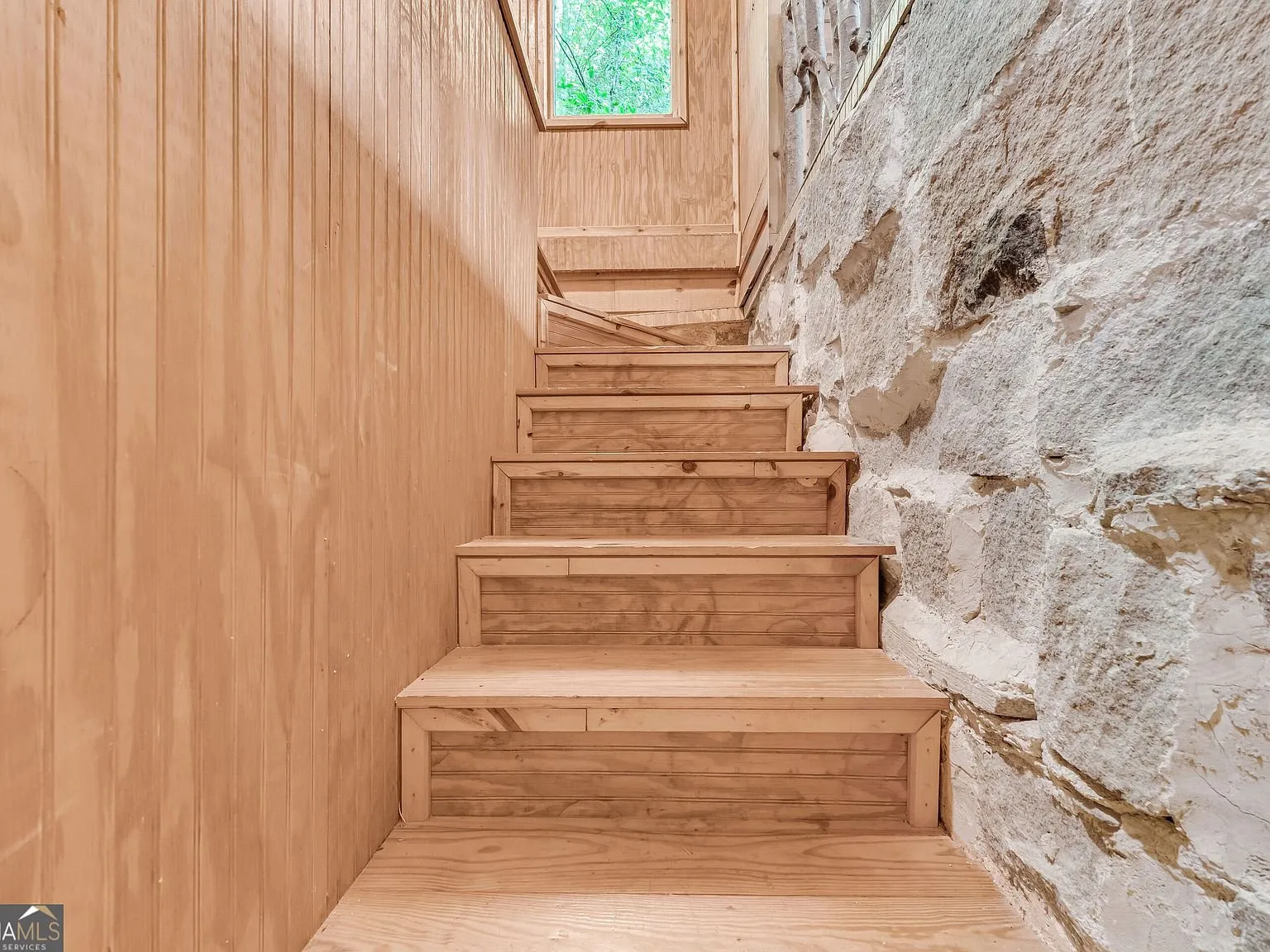 Wood stairs leading up to the loft level