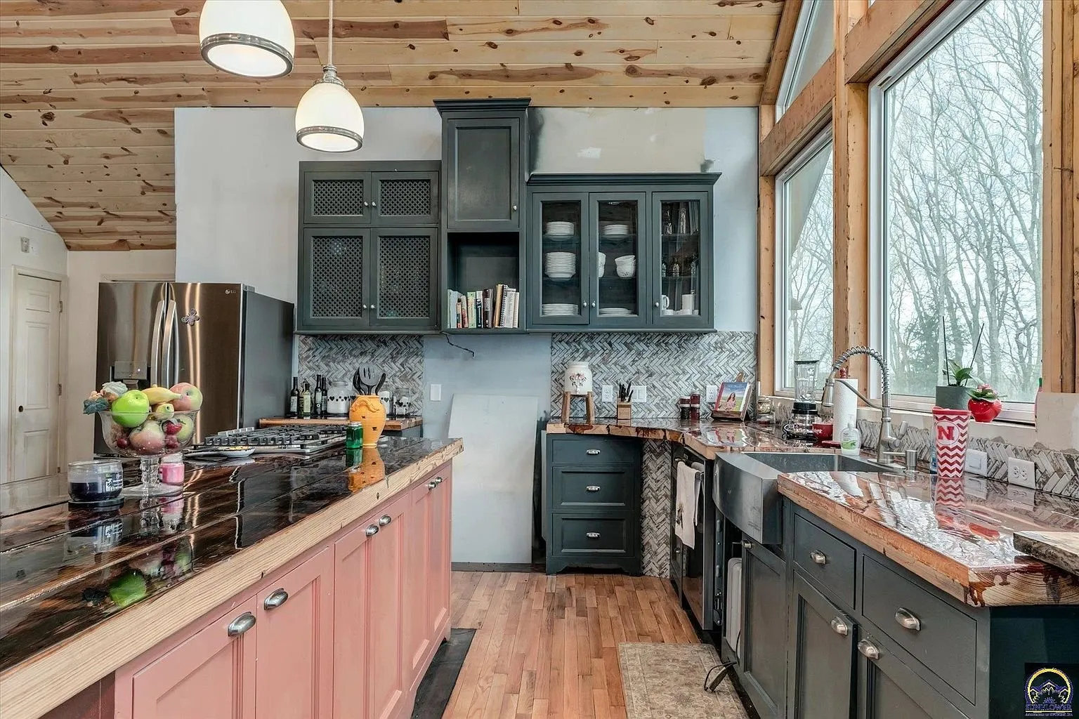 The kitchen counters along the window wall with the sink