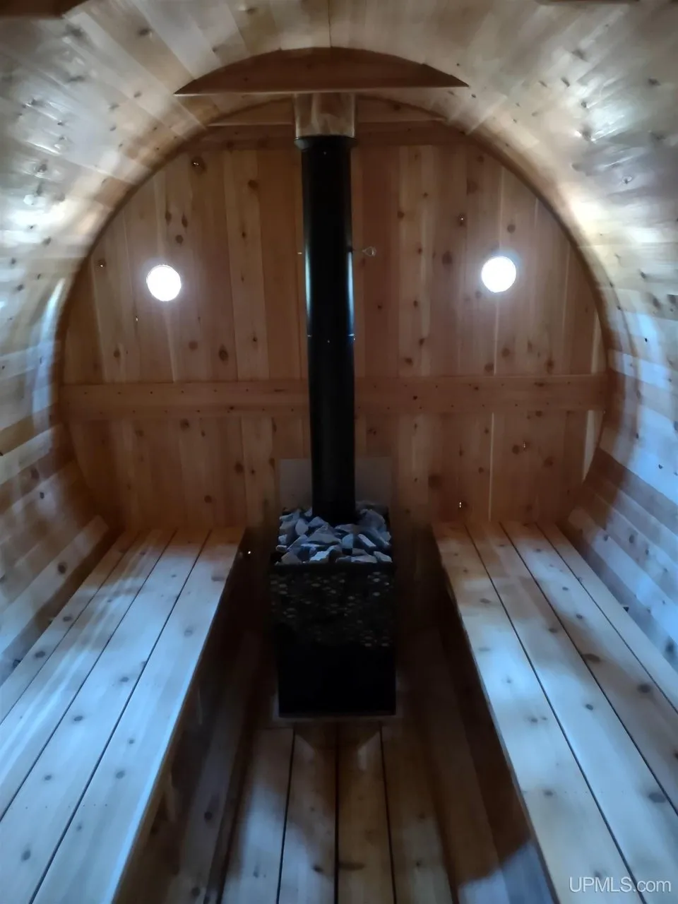 Inside the barrel sauna with the stove and bench