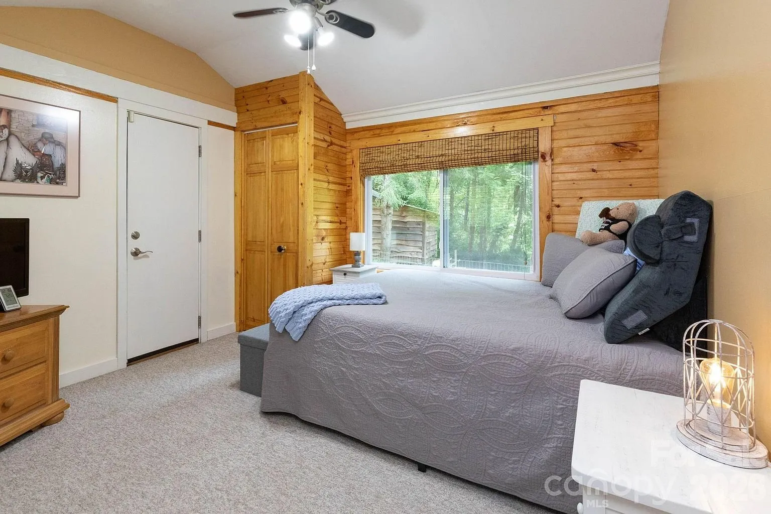 A bedroom with the door to the porch