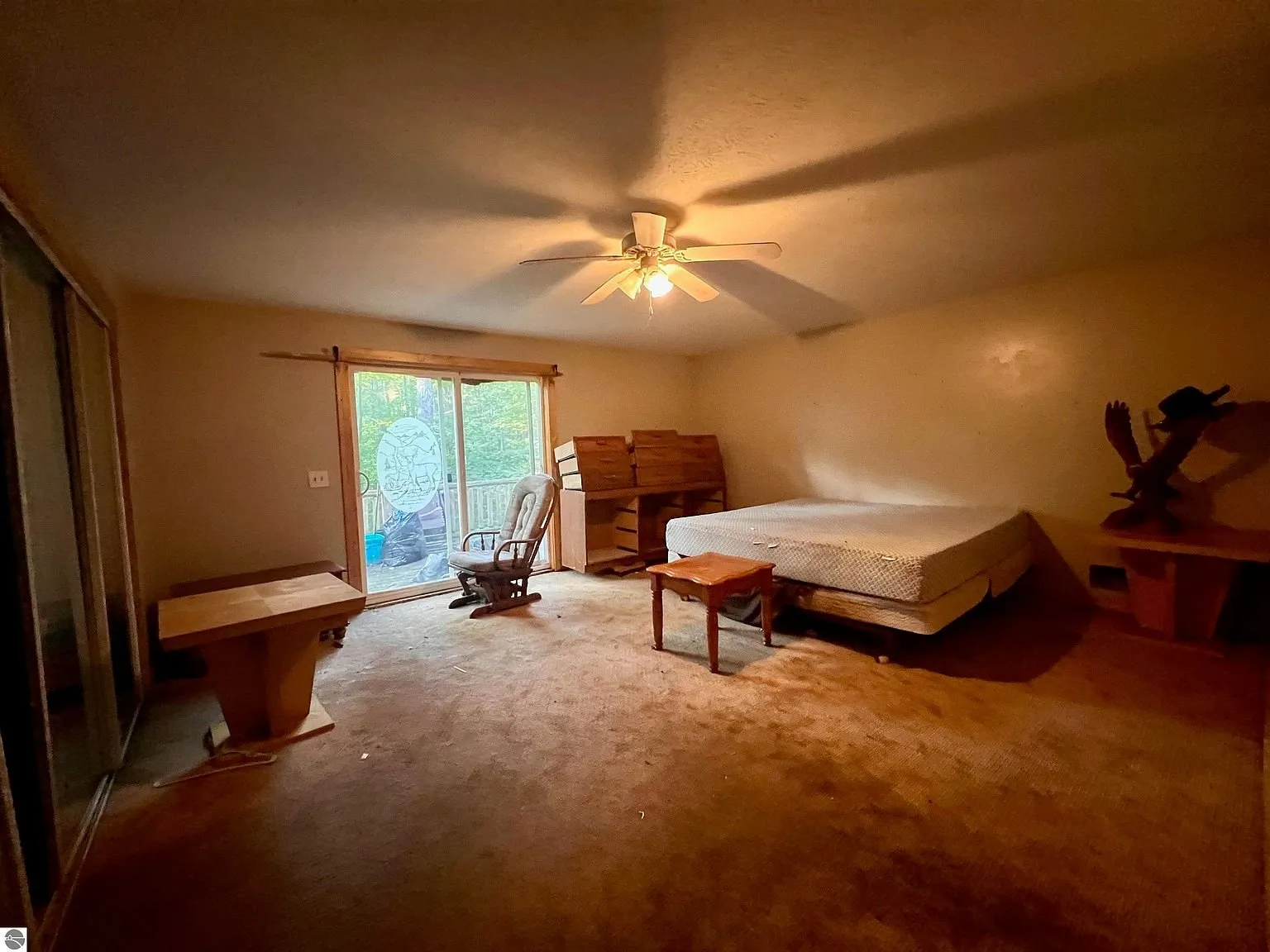 The other upstairs bedroom with the mattress and the balcony door