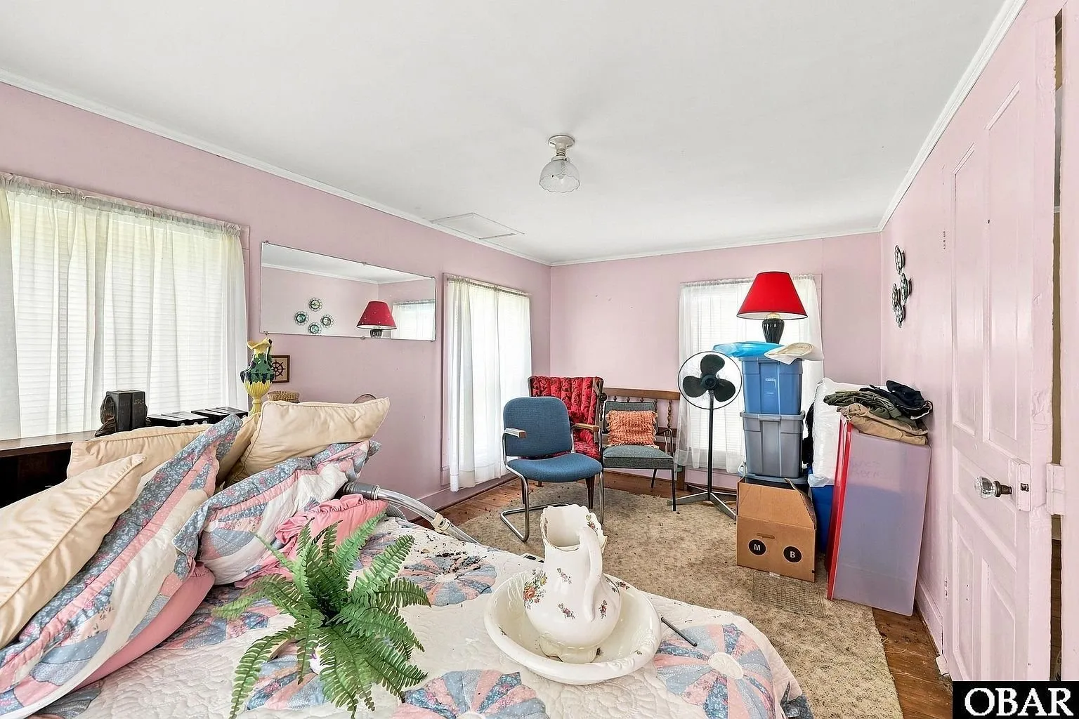 The pink room with a bed and a window air conditioner