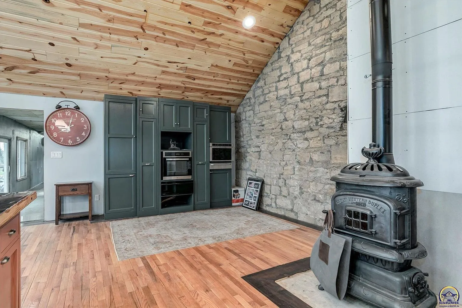 The stove in the kitchen corner against the stone wall