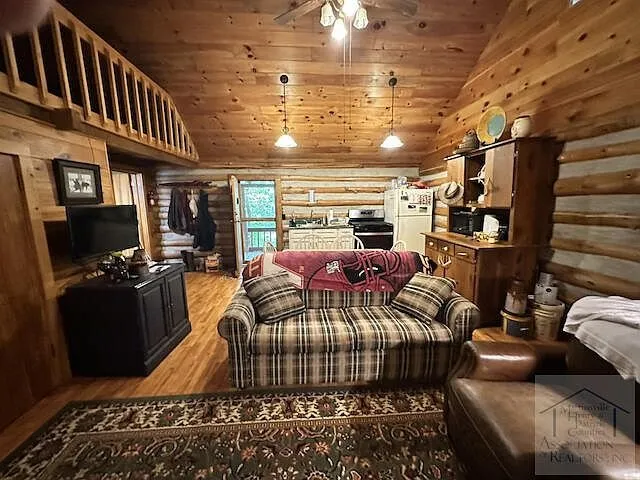 The living room from the loft stairs with the kitchen beyond