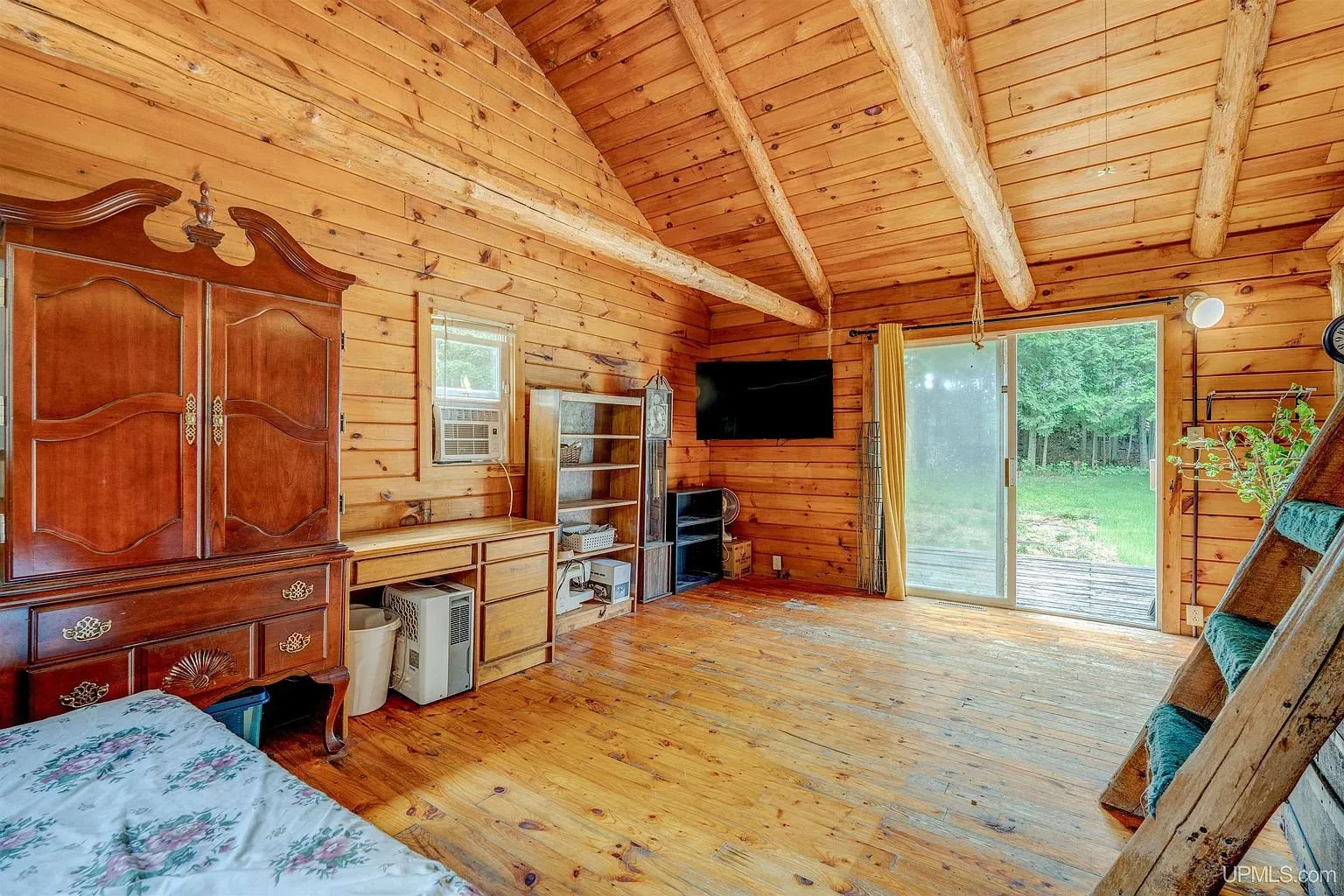 The wardrobe and dresser by the sliding door