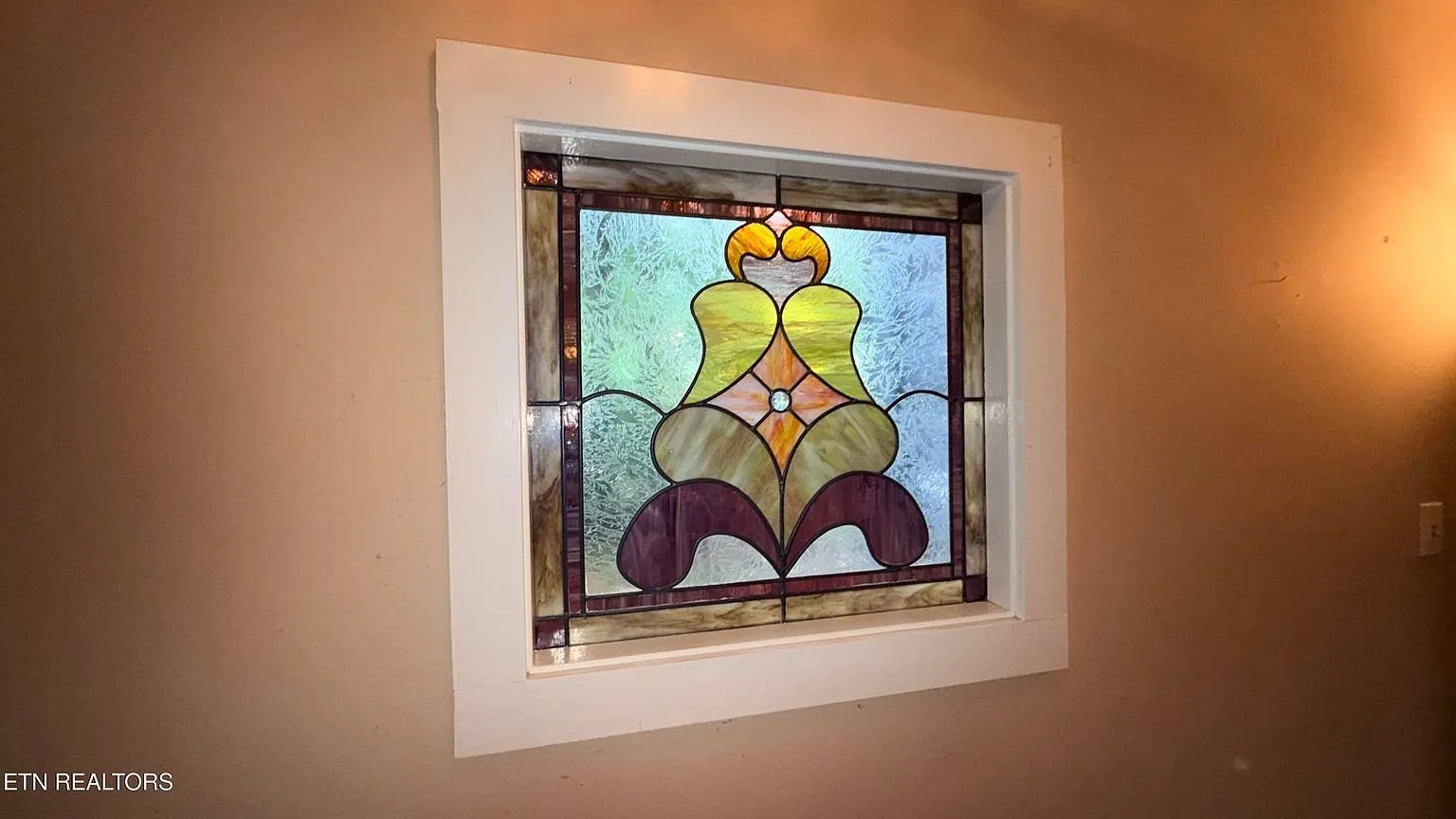 A stained glass window set into the wall