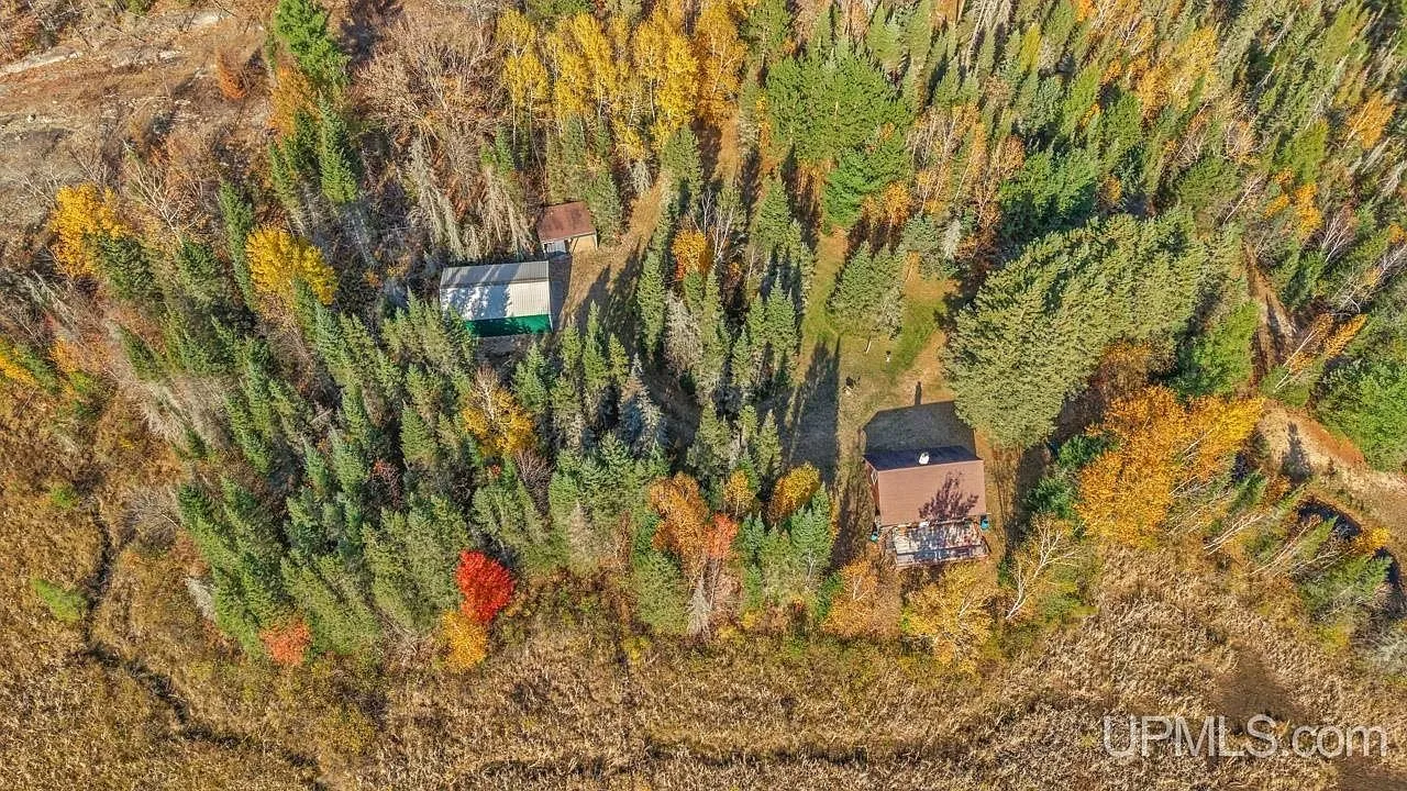 A wide aerial view with the estimated property lines overlaid across the rolling, forested terrain
