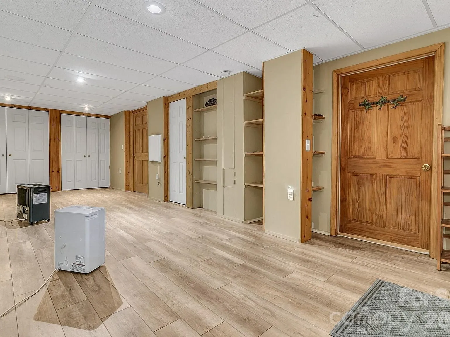An open flexible room in the lower level with built-in shelving