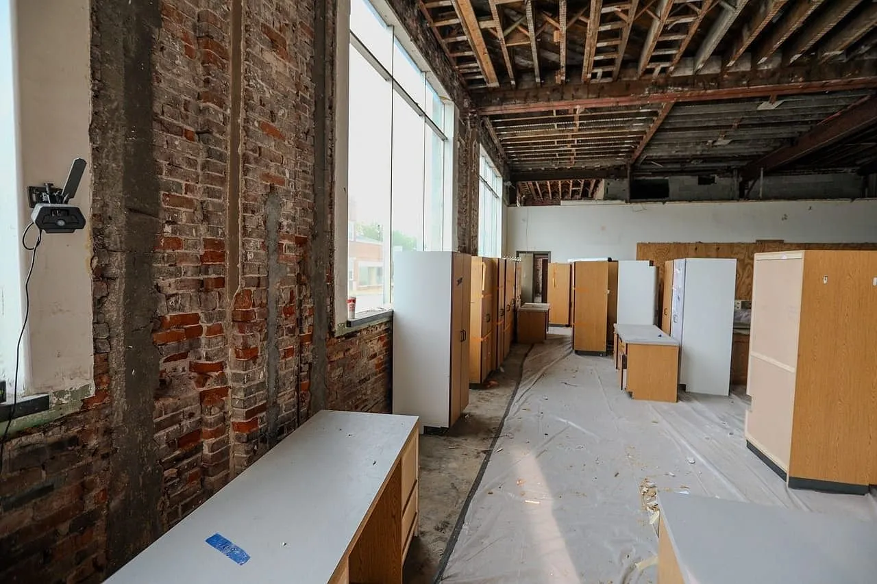 The ground floor with the ceiling removed and the brick wall stripped